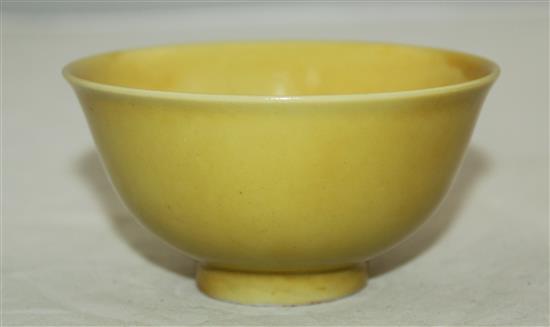 A Chinese yellow glazed small flared bowl, Kangxi six character mark and possibly of the period, diam. 9.5cm